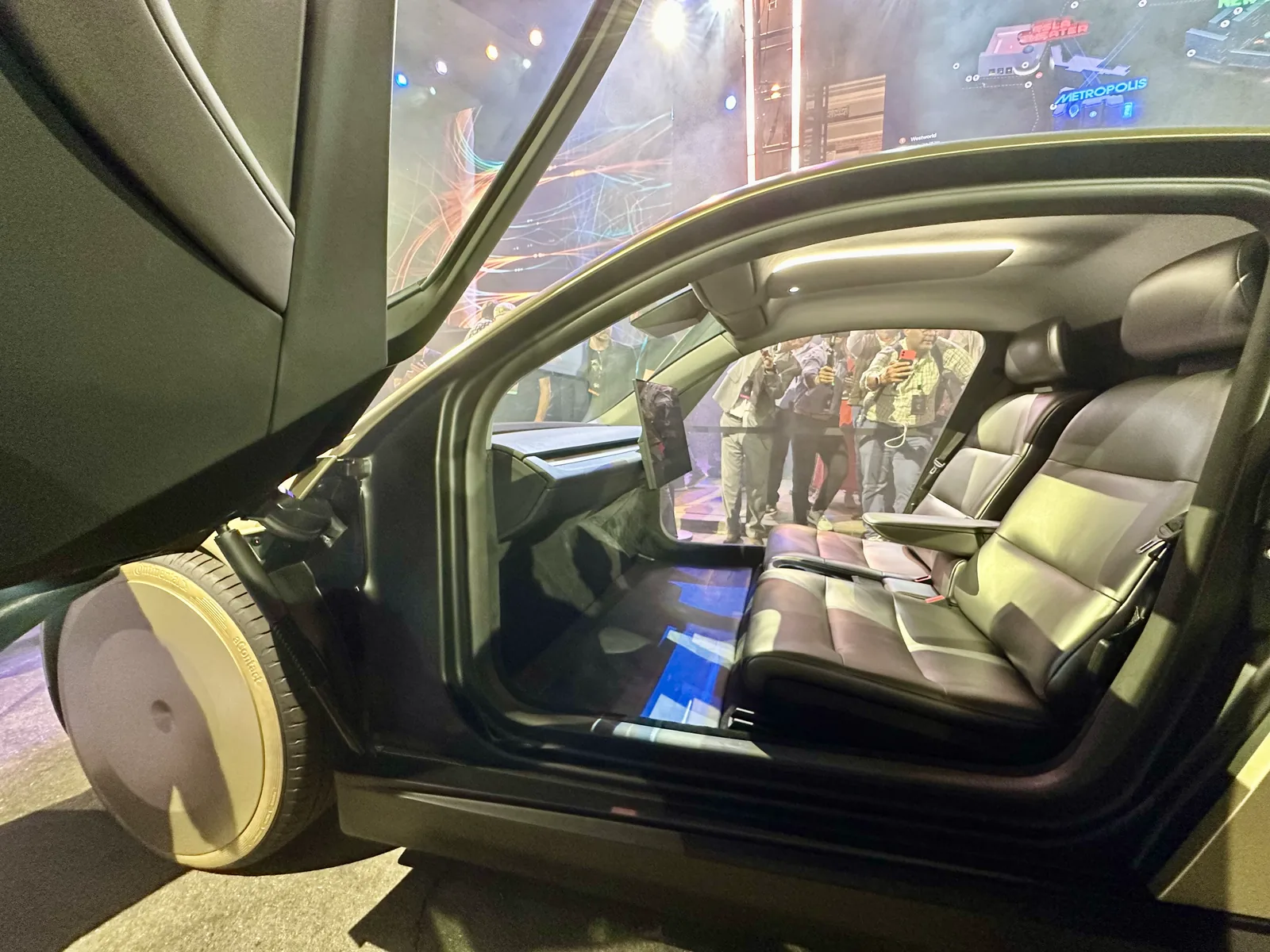 Two seats and a centre display inside a Tesla Cybercab at its public unveiling.