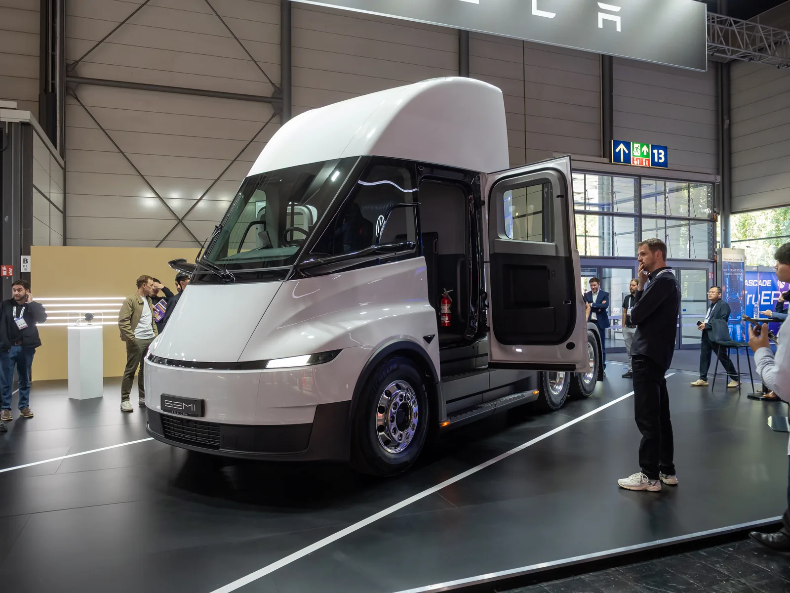 A white Tesla Semi with its cab door open on display at IAA Transportation 2026 in Hanover.